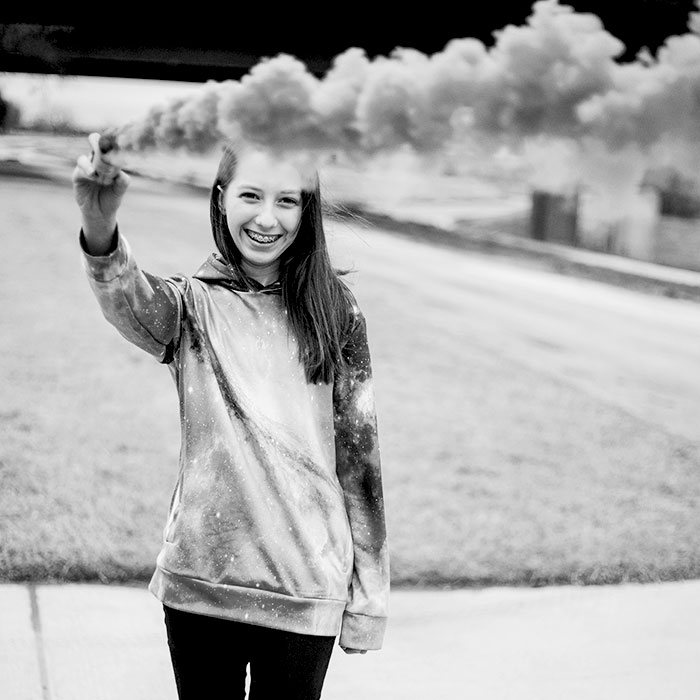 gladney-girl-smiling-wiht-color-smoke